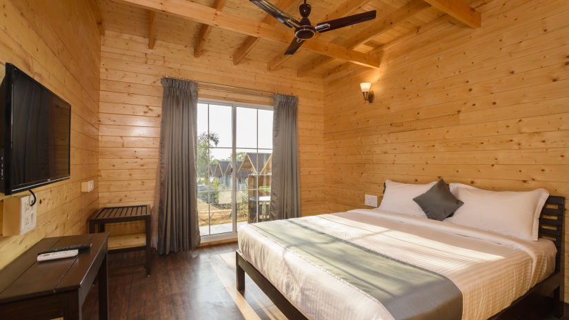 The wooden interiors of the bedroom - White Wood Resort, Morjim