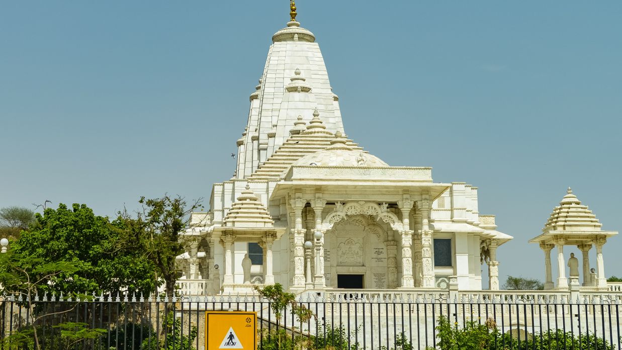 a beautiful temple built with white stones and surrounded by green trees, shot during the day @ Lamrin Norwood Green, Palampur