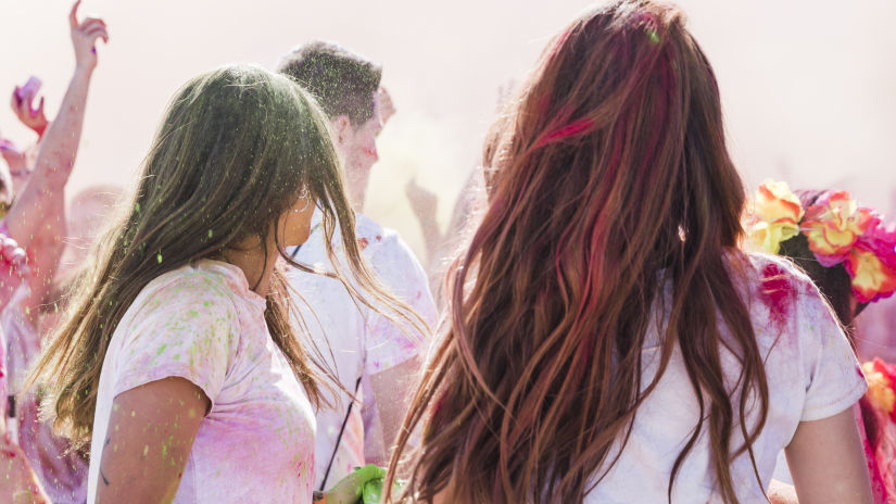 Women and men gathered together to celebrate holi on a beach - andaman holi celebration