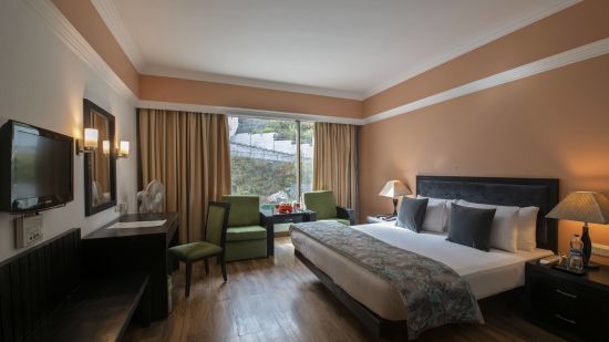 Premier Room with a bed overlooking a window at Mastiff Grand, Manali