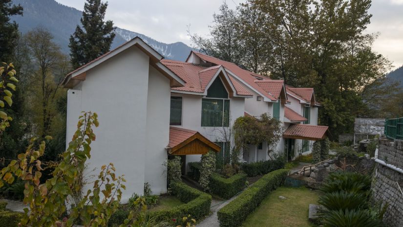 exterior of the cottages at Mastiff Grand, Manali surrounded by greenery