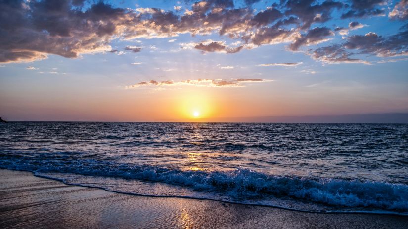 Sunset at a beach on a cloudy day