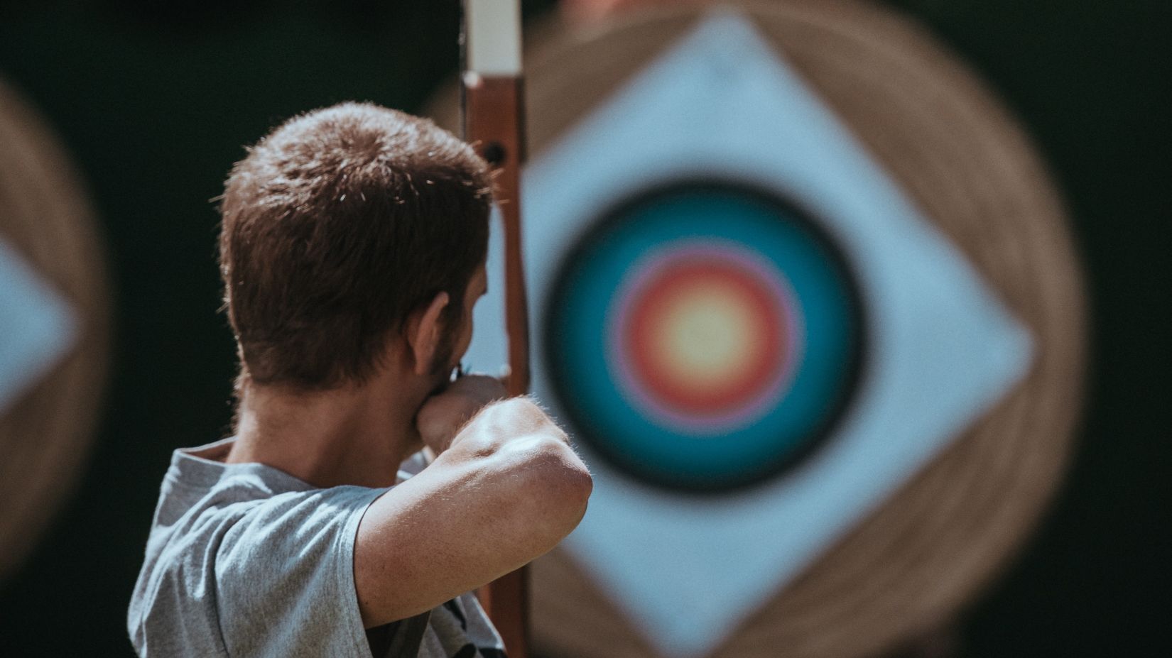 A person about to release the bow at the target