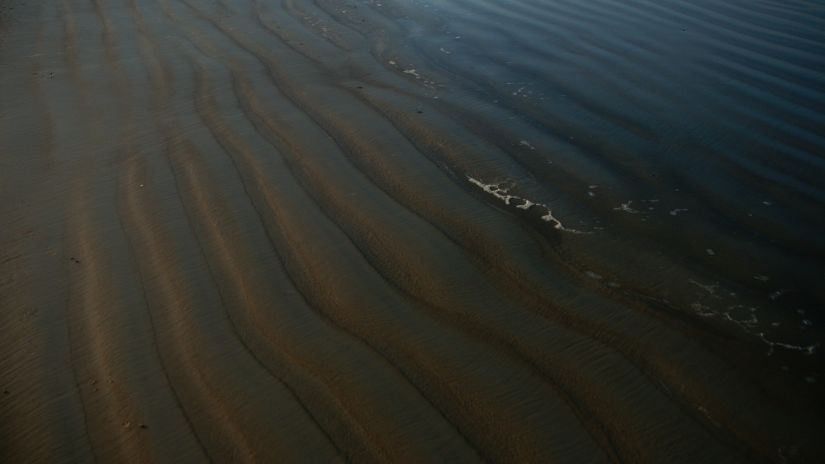 An overview of the soil of Colva Beach that is shown up in waves - South Goa Tourism