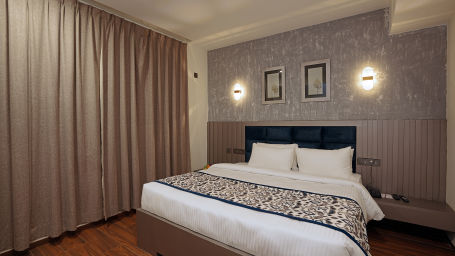 A cosy room with plushy bed and warm light at Grand Continent, Anjuna - A Sarovar Portico Affiliate Hotel  