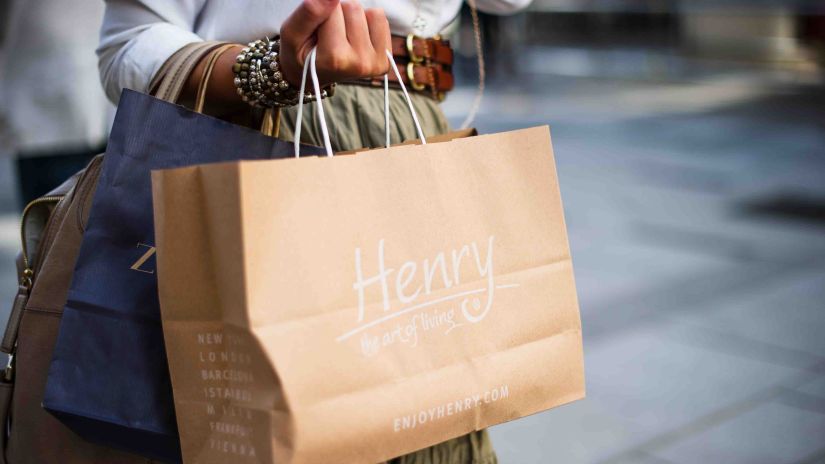 a woman holding a bunch of shopping bags