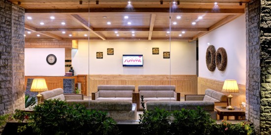 alt-text Lobby  area with sofas and frames on the wall at Summit Chandertal Regency Hotel & Spa