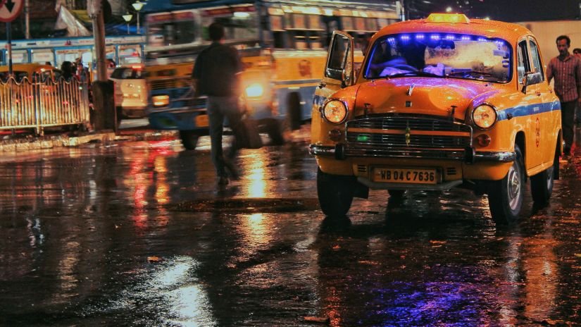 a taxi driving in the rain