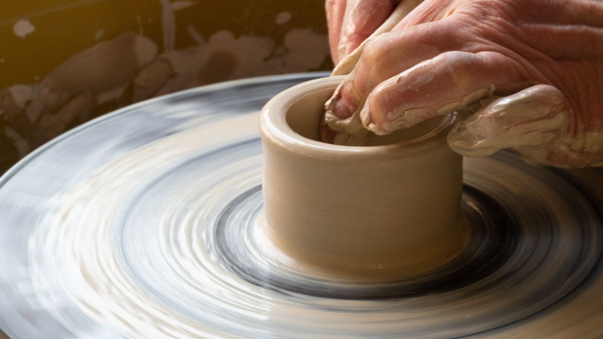 an image of a person very carefully shaping a clay dough to an earthen pot @ Lamrin Norwood Green, Palampur