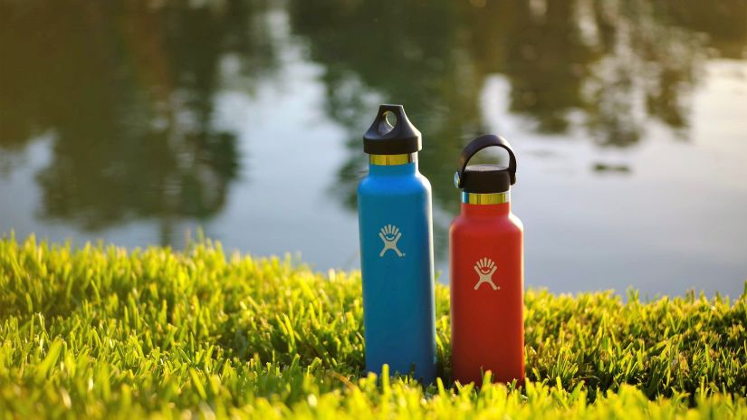 water bottle on grass with a water body in the background