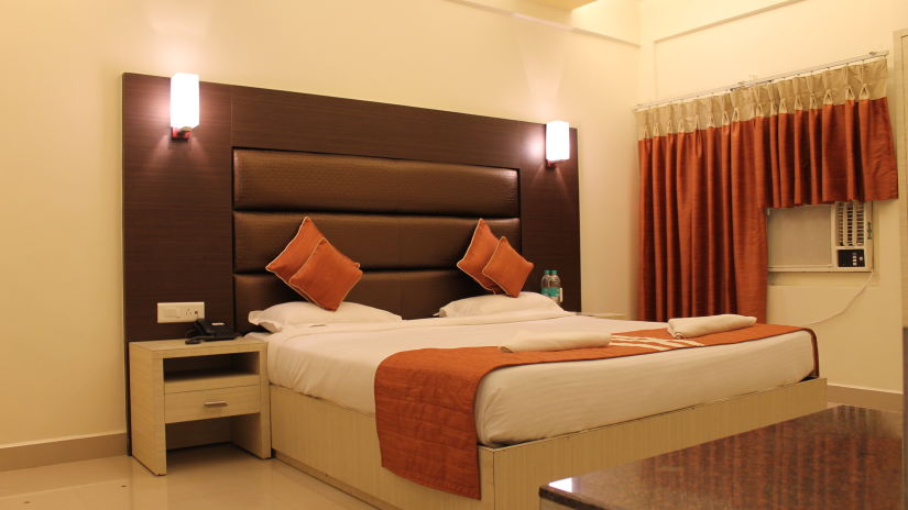 A double bed with side tables, lamps and headboard at Executive Room at hoetl Shompen