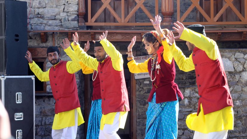 People dancing in colourful attire