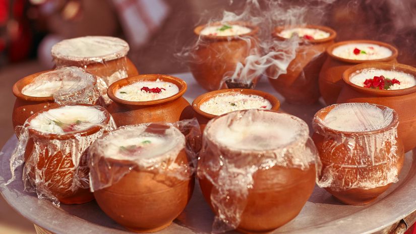 a closeup shot of lassi served in earthen cups