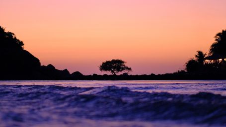 Palolem beach glistens under a colorful sky during dusk - Nightlife in South Goa