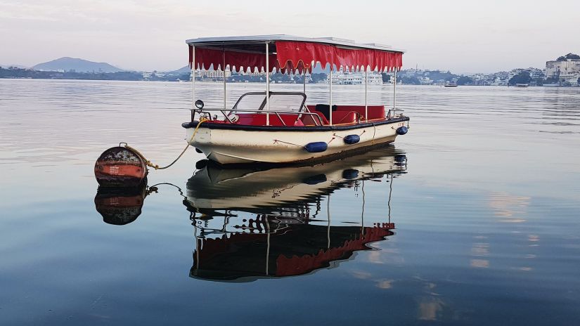 A boat amidst blue waters and clear skies