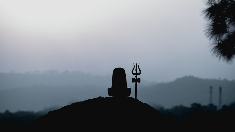 silhouette of shiv linga kept on top of a hill