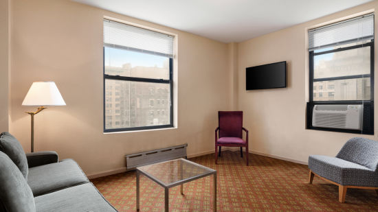 alt-text Standard Non Smoking Jr. Suite are spacious and feature a living room with sofas and a table