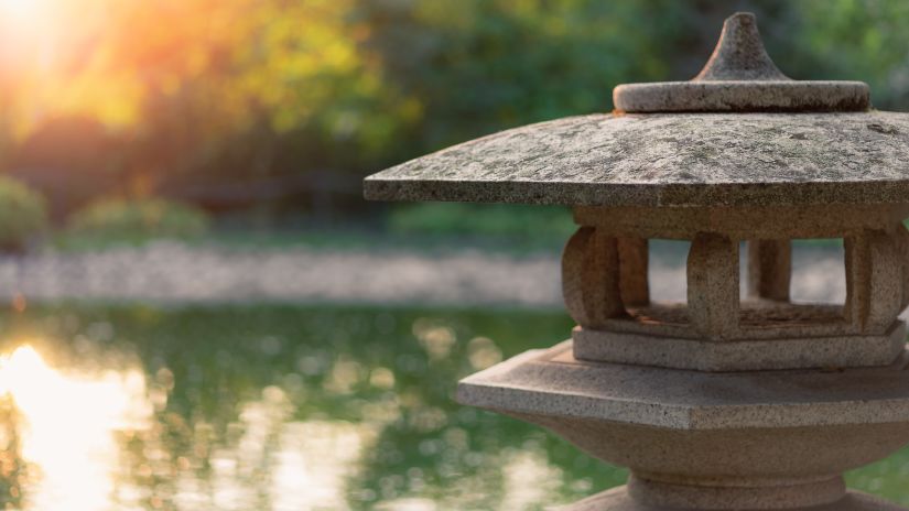 a stone structure by a water body