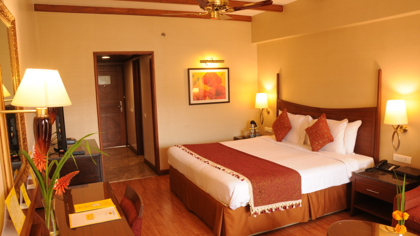 double bed in one of the rooms at at The Carlton Kodaikanal 