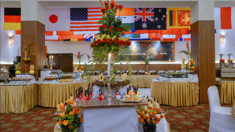 Clarks Varanasi - the sitting area with flags of different states behind at Central Hall in Varanasi 1