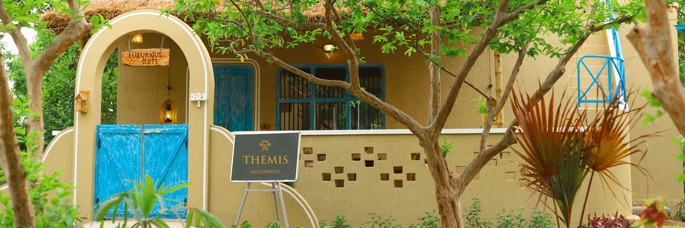 exterior of luxurious suite surrounded by lush greenery at Themis Mudhouse - A Nature's Retreat Resort & Wellness