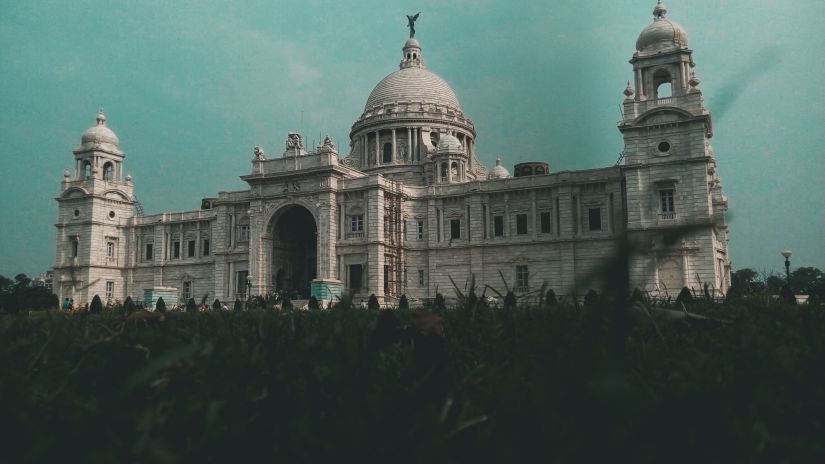 Victoria Memorial building made with white marble with a garden in foreground