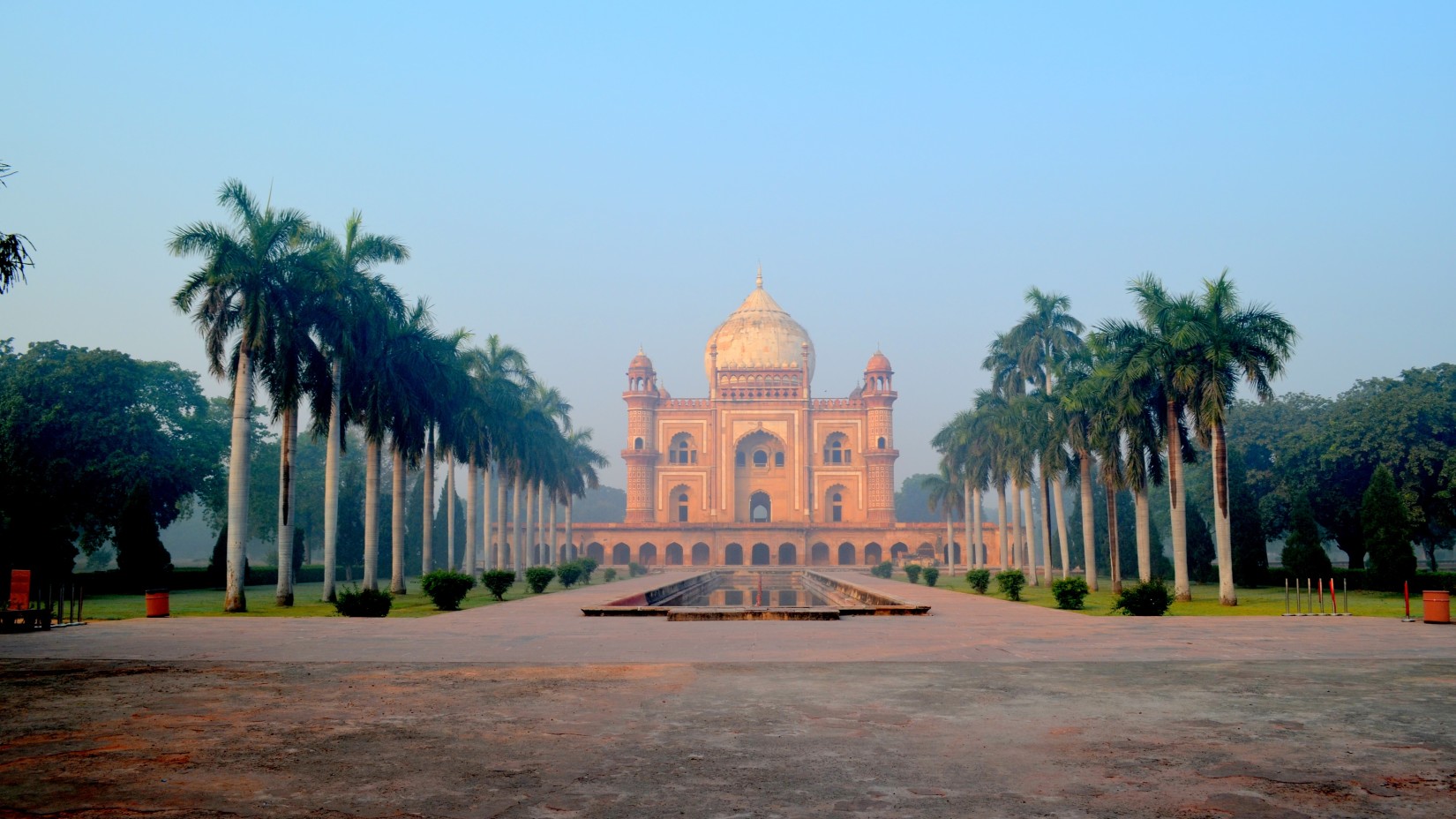 a peach coloured fort surrounded by trees