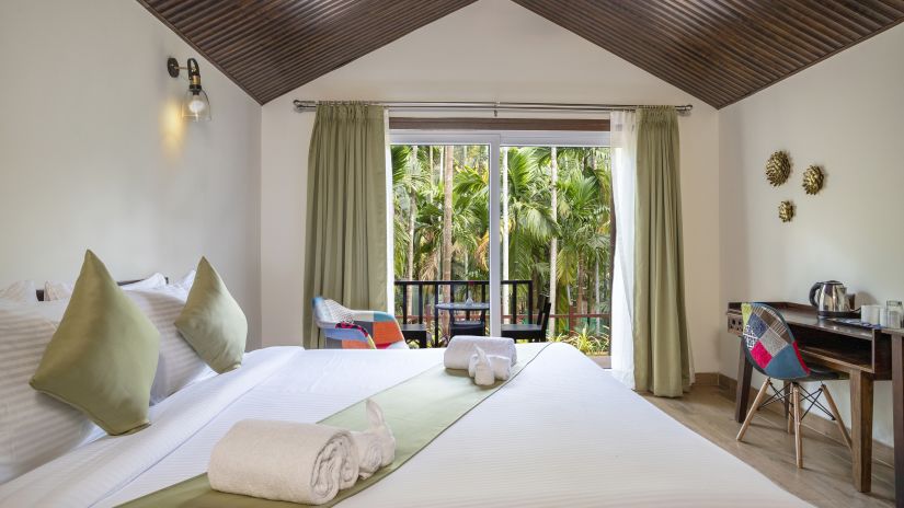 A view of our cottages with a view of the garden seen from the inside - Stone Wood Nature Resort, Gokarna