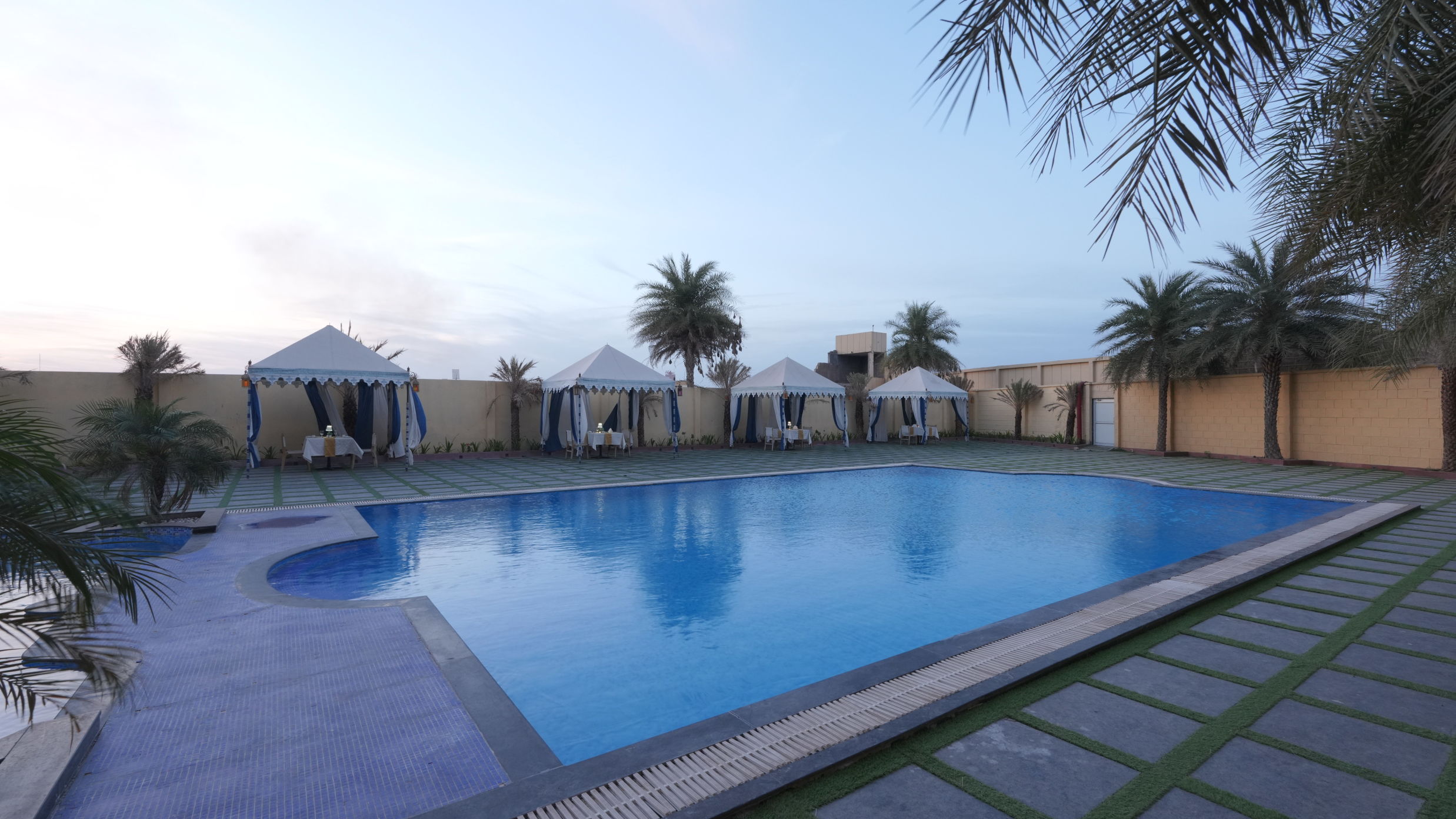 Side view of the The Palm Pool and tent seating at The Garden Ananta Elite Rajkot 2