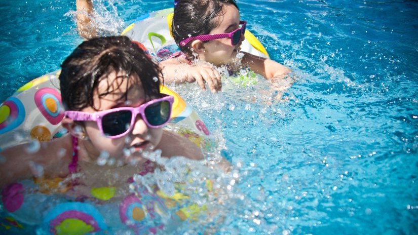 tow kids swimming in a water park