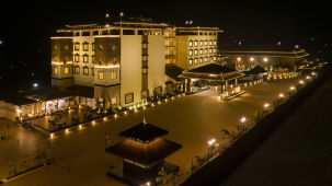 An aerial view of the facade at night - Shyama Sarovar Portico Orai