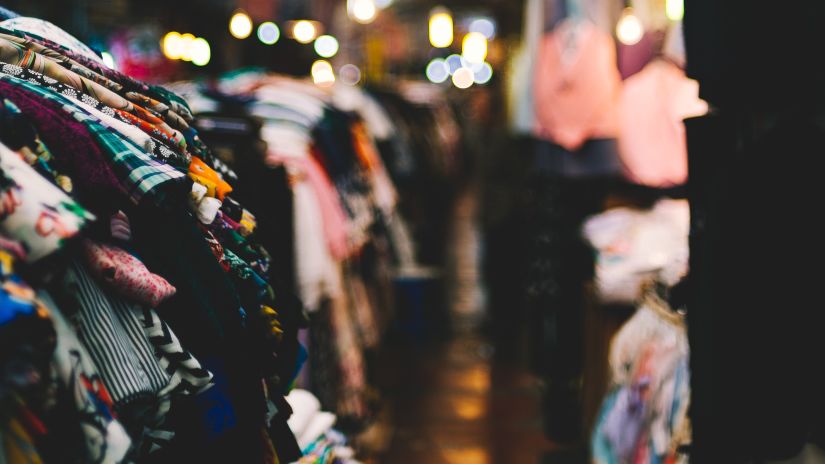 clothes hanging from hangers at a shop