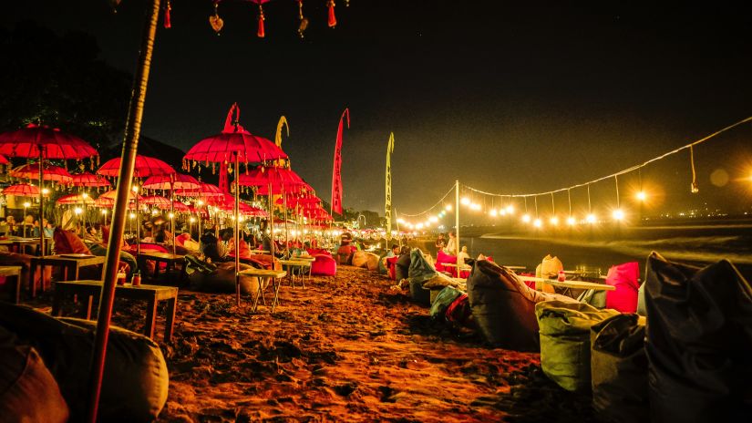 decorated beach during the nigh time with lights on