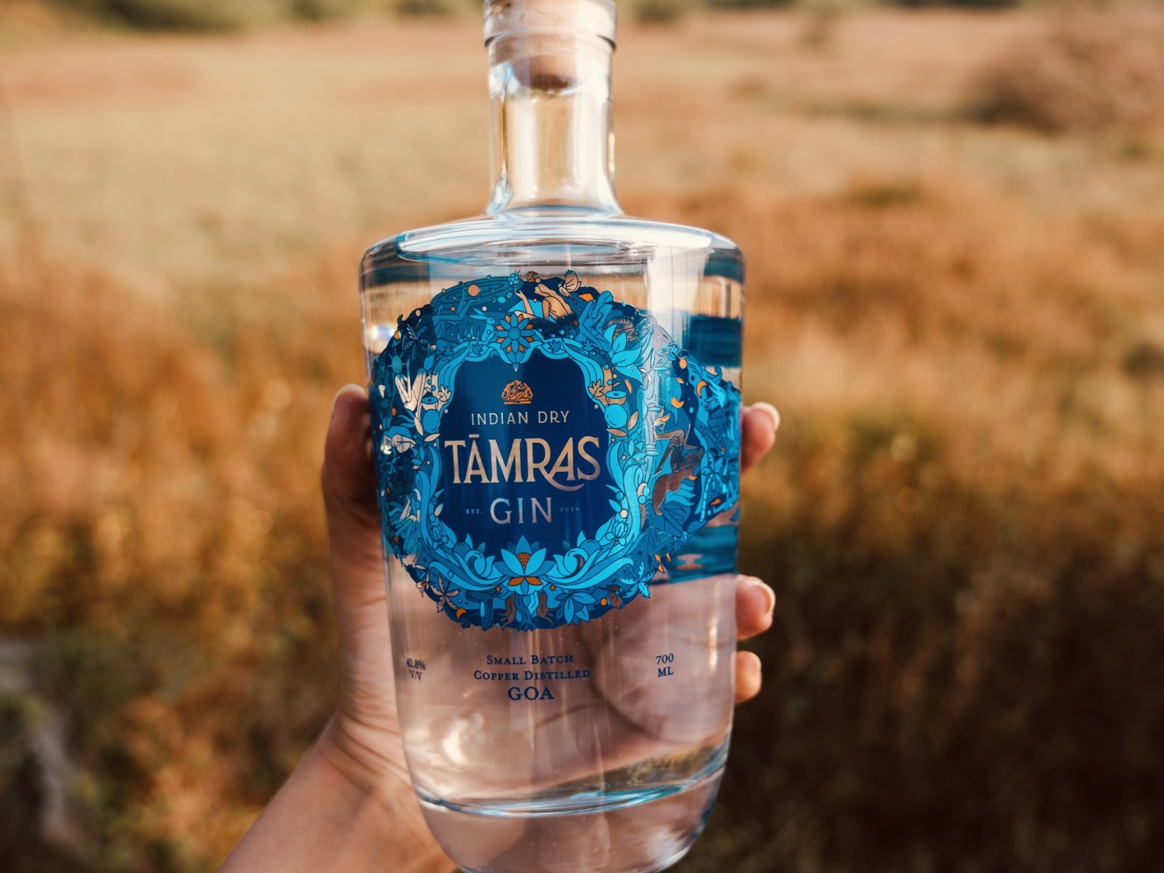 A person holds a Matinee Gin bottle