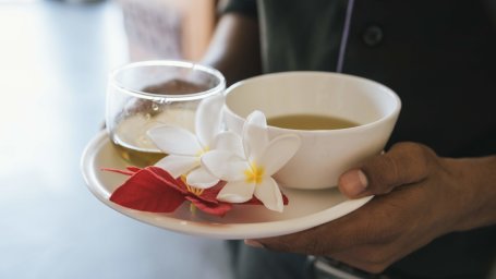 man holding a cup of tea Rejuvenate- The Golden tusk