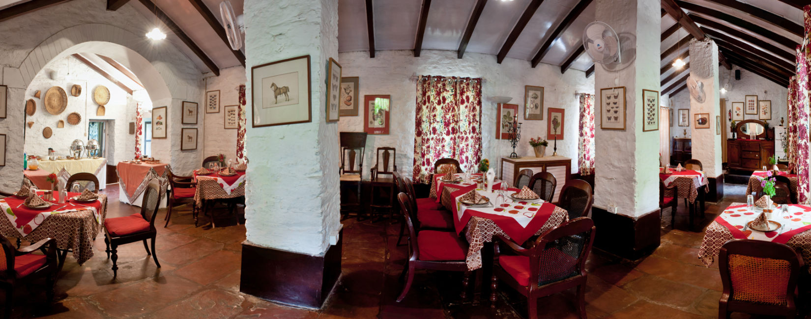 The Ramgarh Bungalows - full view of dining area and a red-white theme