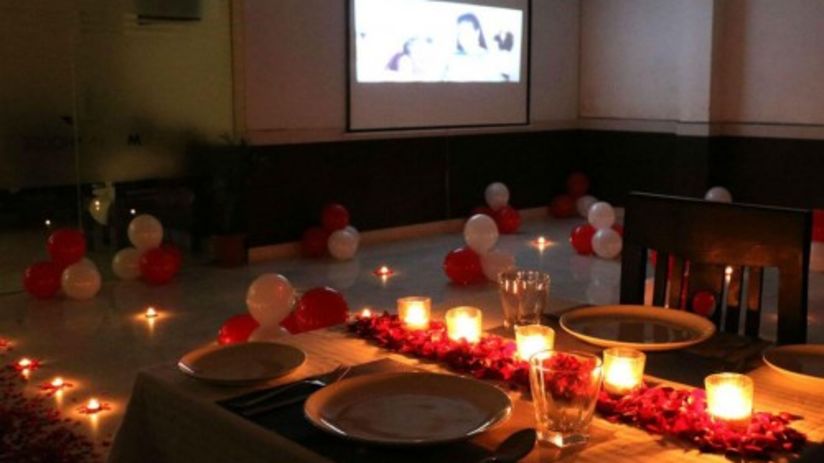 a room filled with balloons and other decorations and a projector