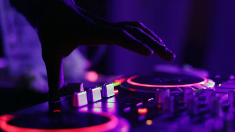 A DJ using the track table to play music at a party