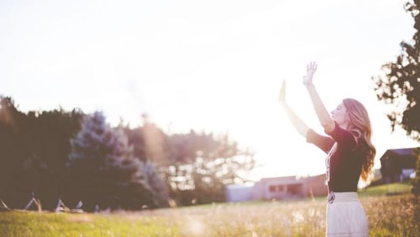 Woman enjoying sunlight in a garden   