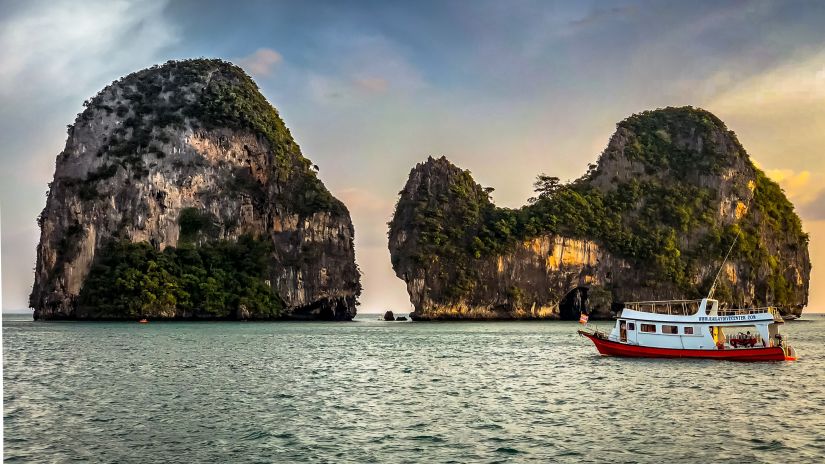 white-boat-sailing-near-islands-during-golden-hour-1481096