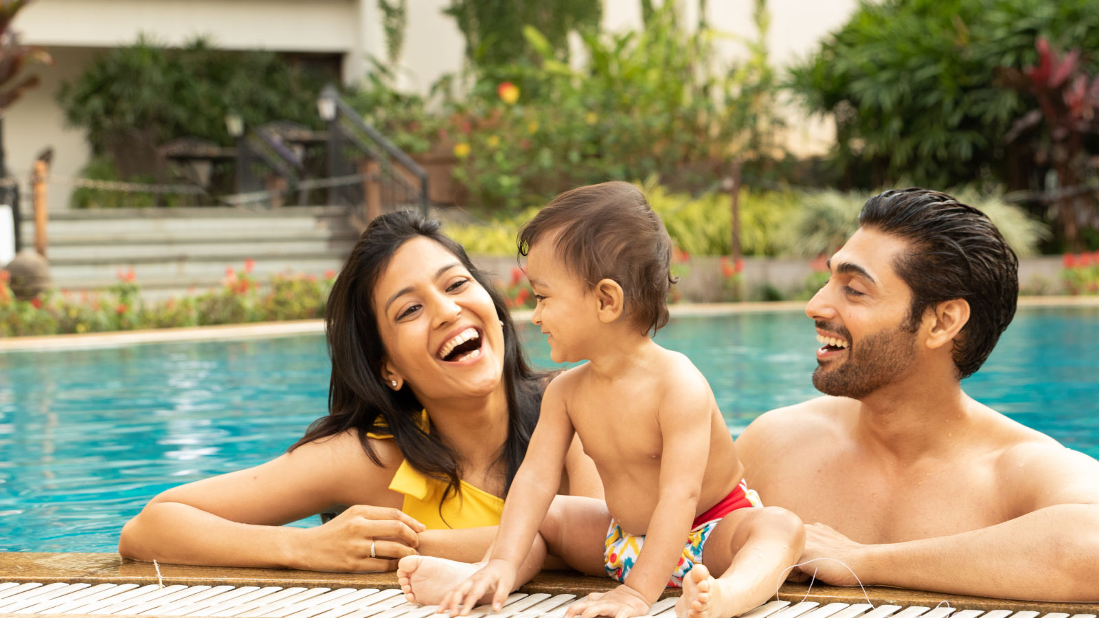 Parent and kid enjoying the swimming pool