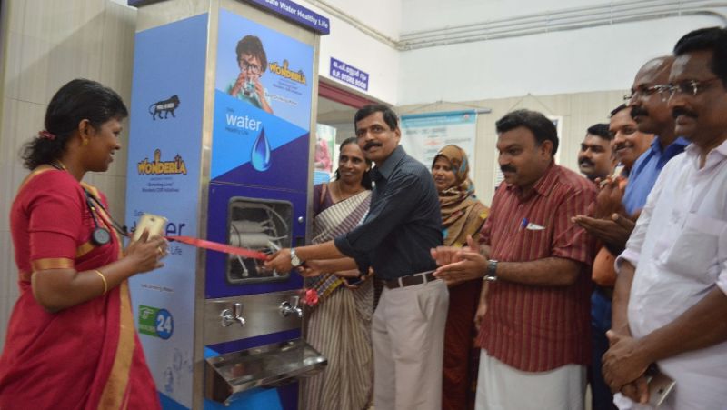 people inaugurating a water cooler