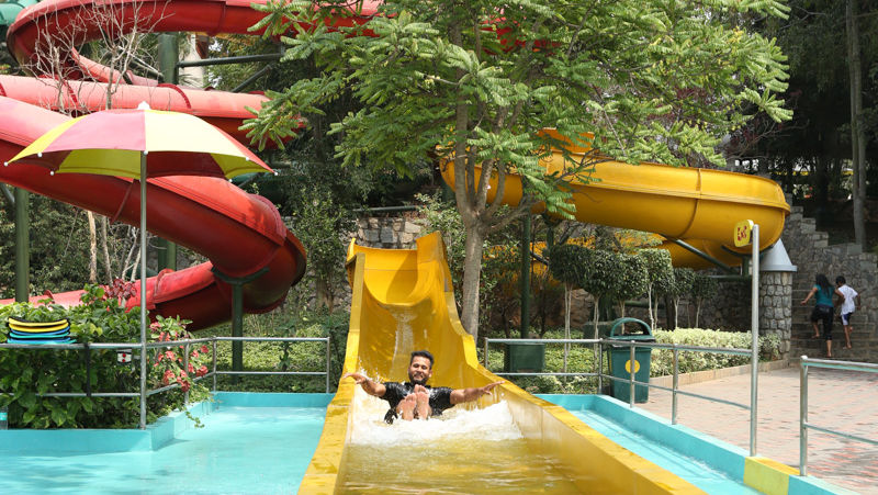 Man sliding down a yellow water slide