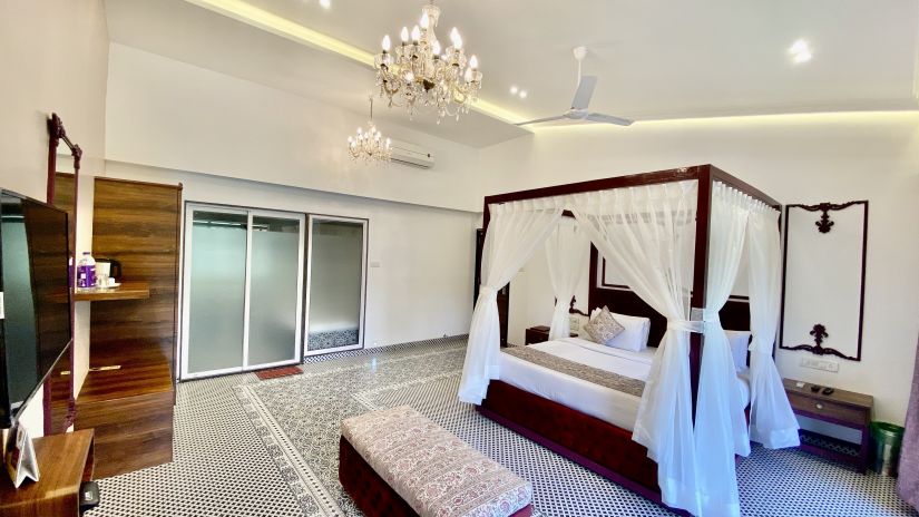 plush room interiors with a 4-poster bed offered at Moghul room - Zara's Resort