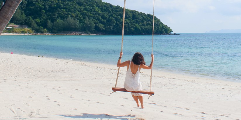 woman swinging on the beach