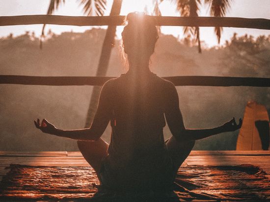 Woman meditating during Golden hour