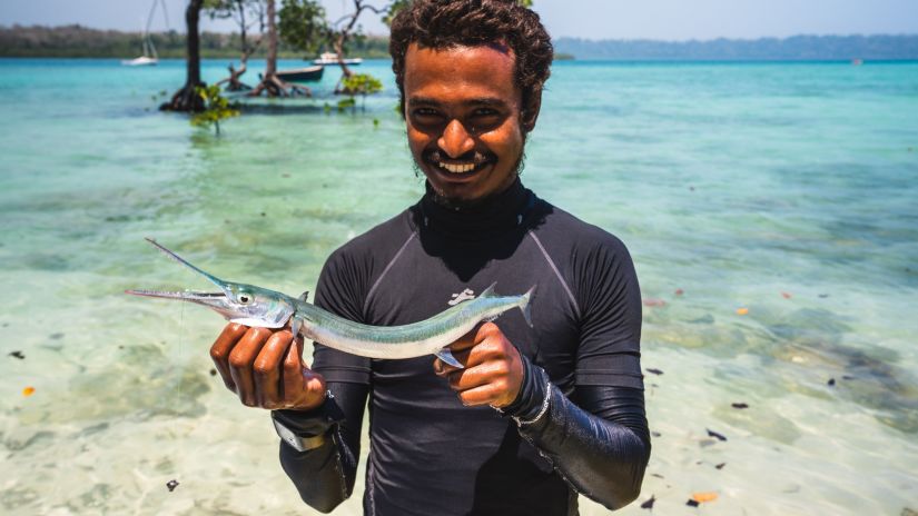 A man standing with a fish