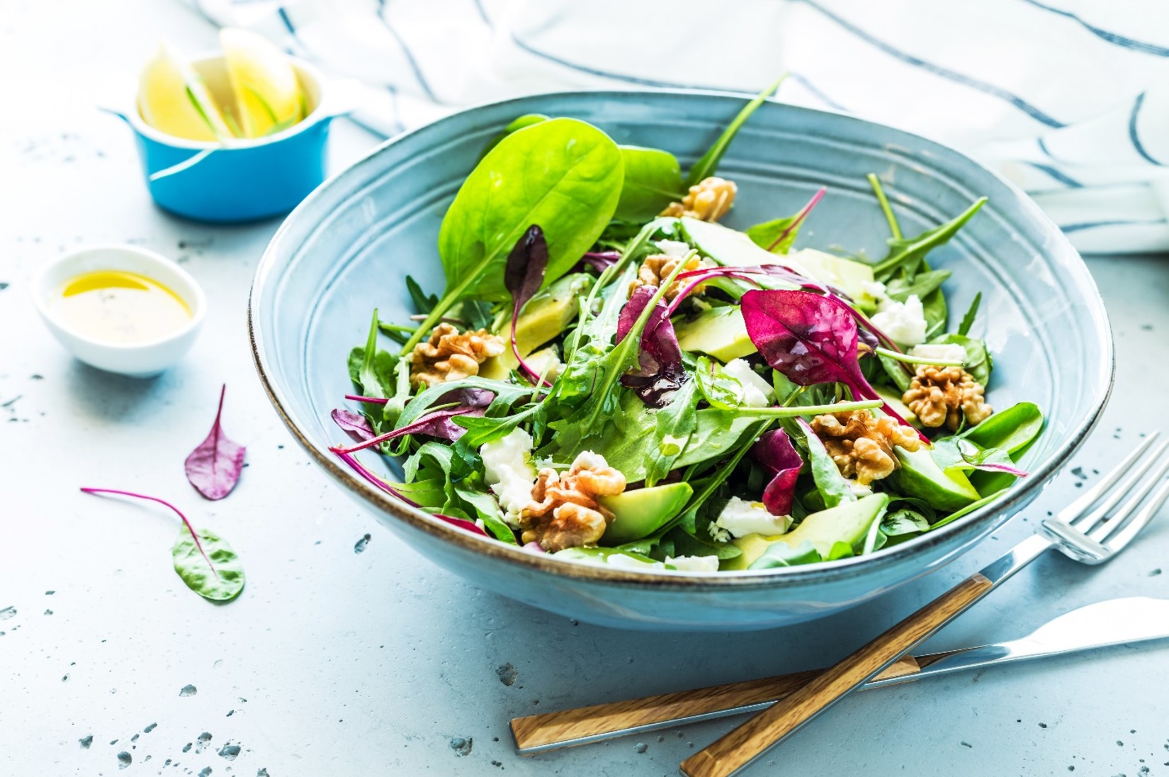 A bowl of salad on a table with sides