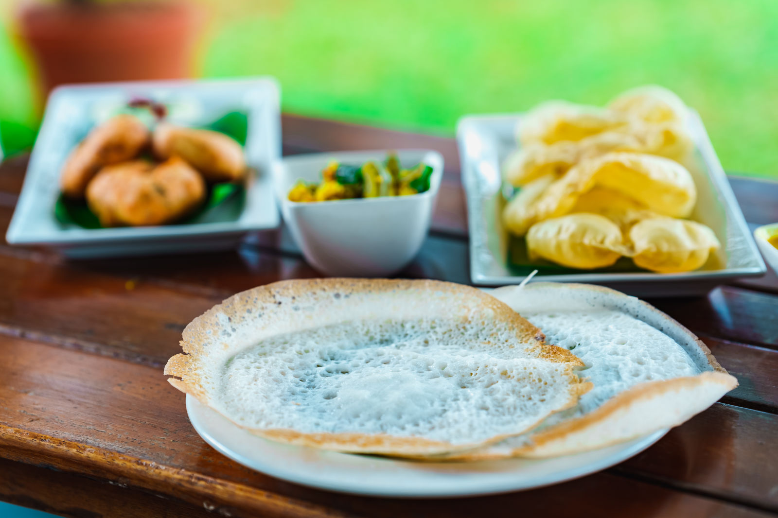 Rhythm Kumarakom - appam vada puri and a side dish on a table