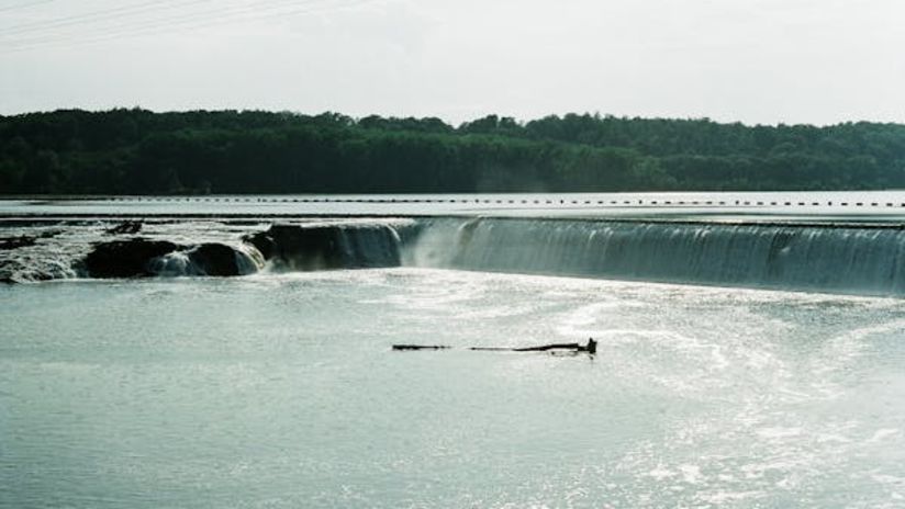 A water reservoir dam with flowing water.